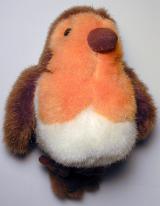 High Angle View of Fuzzy Robin Song Bird Childs Toy Lying on Back on White Background