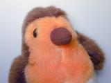 Robin red breast kids soft stuffed toy or ornament in a close up view of the breast and face over grey
