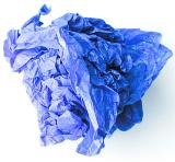 Close up of scrunched up blue tissue wrapping paper on white background