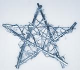 Decorative silver wicker Christmas star decoration bound with wire for a rustic or country Xmas theme, over white
