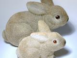 a pair of easter bunny rabbit ornaments on white