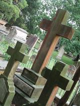 three cross shaped stone headstones in graveyard