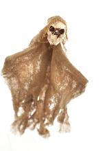 Rustic scary homemade Halloween skull doll wrapped in frayed burlap or hessian over a white background