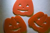 jack-o-lantern halloween shapes with smiles, lit with angled light from above