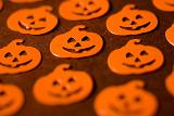 jack-o-lantern pumpkin halloween shapes in orange on a brown backdrop