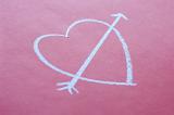 concept of school romance a chalk love heart and arrow shape on a red pink background