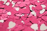 an assortment of pink heart shaped confetti creates an attractive romance themed background image
