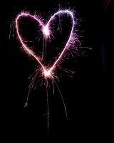a pink and purple coloured love heart shape drawn with a sparkler