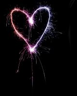 a pink and purple coloured love heart shape drawn with a sparkler