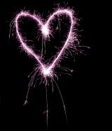 a pink coloured sparkling love heart valentine concept image on a black background