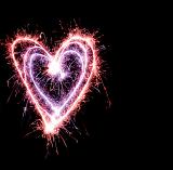 colourful sparkling heart shaped symbols, drawn with a sparkler