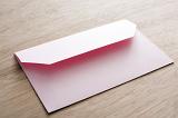 Pink blank Valentines card envelope close-up over wooden table surface