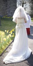 the wedding bride walking to the church door along a path lined with flowers