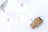 a champagne cork and glasses, opened ready for the wedding toast
