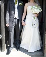 a wedding couple stepping out of the church after the marriage ceremony