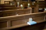 rows of church pews and a bible