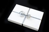 a white wapped wedding present with a silver bow