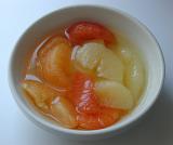Bowl of yellow and pink grapefruit segments for breakfast or dessert, closeup high angle view