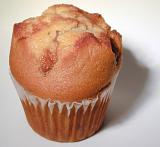 Freshly baked homemade golden muffin for a tasty breakfast or tea time snack, closeup view