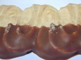 Close-Up of Chocolate Dipped Pastry Dessert on White Background