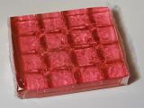 Metal tray of colorful pink jelly for a childs birthday party ready to add hot water and make jelly dessert