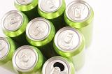 Nine grouped green cans of energy drink viewed from above with eight closed tabs and one that has been pulled and opened