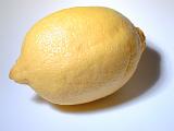Fresh whole yellow lemon rich in vitamin c and a popular garnish and ingredient for its sour tangy taste, on white