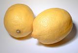 Two fresh ripe yellow lemons, a popular cooking ingredient and garnish with their tart tangy flavor rich in vitamin c