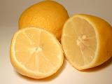 Halved fresh tangy lemons showing the segments and juicy pulp rich in vitamin c