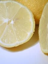 Sliced tangy fresh lemon rich in vitamin c used as a garnish and cooking ingredient for its sour taste