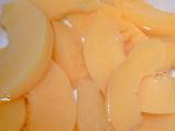 Background texture of canned peach slices in juice ready to be served for dessert