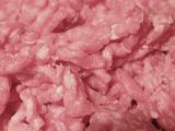Closeup background texture of raw mince meat in a food and catering concept