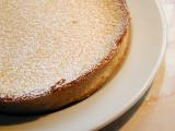 Freshly baked golden crispy pastry pie crust sprinkled with icing sugar served on a plate in a close up culinary or baking background
