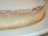 Texture of a freshly baked pastry pie crust topped with sprinkled icing sugar or powdered sugar served on a white plate