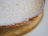 Close up detail of a freshly baked pastry crust on a pie with the top sprinkled with icing sugar or powdered sugar