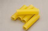 Dried Italian cannelloni pasta with its traditional hollow tubes made from eggs and durum wheat on a grey background