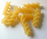 Close up of uncooked dried Italian fusilli pasta with its distinctive spiral shape made from durum wheat