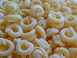Background of circular dried uncooked Italian pasta made from durum wheat dough for traditional mediterranean cuisine