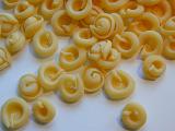 Dried uncooked Italian pasta made from durum wheat dough and eggs scattered on a white background for a healthy Mediterranean cuisine