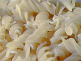 Background texture of spiral dried Italian fusilli pasta for a healthy Mediterranean cuisine