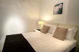 Modern bedroom with neutral decor and a comfortable double bed in bed and breakfast accommodation for travelers