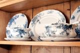 Close up of sauce boats and dinner plates in blue and white crockery on a wooden dresser