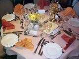 Formal dinner table at a catered event with elegant linen and silverware with name tags and place settings
