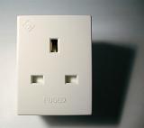 White plastic British grounded adaptor or electrical socket for a plug