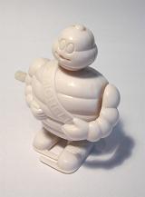 Still Life of Michelin Man Mascot Wind Up Toy on White Background