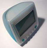 Plastic desk electronic clock designed as a blue and gray PC monitor or CRT TV set, close-up with shadow and copy space on gray