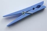 pretty cornflower blue clothes peg for hanging laundry on the line lying diagonally across the frame