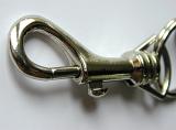 Closed metallic key locker ring, close-up with shadow on gray background