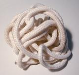 Pair of clean white laces lying in a twisted heap on a white background viewed from above