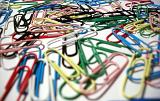 Pile of colorful paperclips in a school or office stationery supply viewed low angle with shallow dof